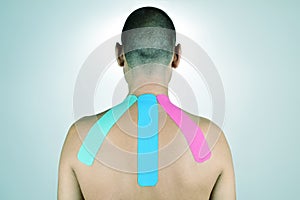 Young man with some strips of elastic therapeutic tape in his ba photo