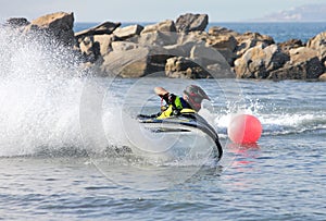 Young man speeding along on jetbike during a race