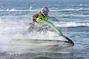 Young man speeding along on jetbike during a race