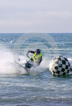 Young man speeding along on jetbike during a race