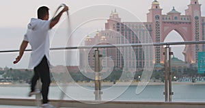 Young man is spinning in a massive hoop, wheel gymnastics, Dubai vacation, 4k