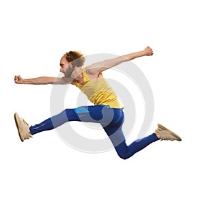 Young man in sportswear running in a jump isolated on white background. Overcoming difficulties. Motivation