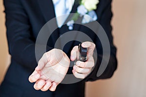 Young man spray perfume