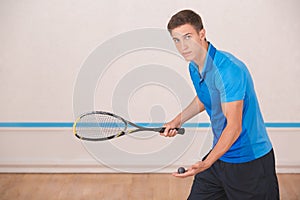 Young man squash player exercise game in the gym