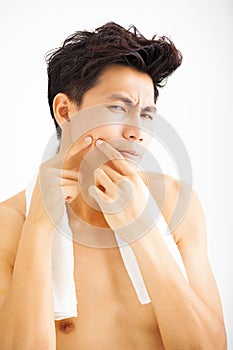 young man Squeezing pimple