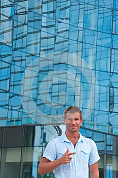 Young man stand in front of modern business building
