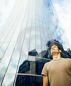 Young man stand in front of modern business building
