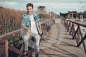 Young man standing on a bridge