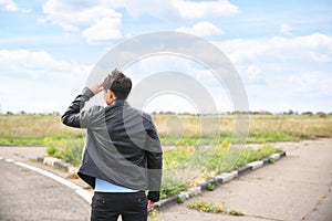 Young man standing at crossroads. Concept of choice