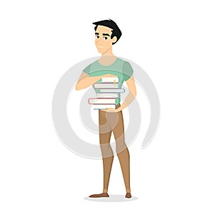 Young man standing and holding a pile of books photo