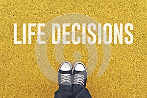 Young man standing at Life Decisions sign