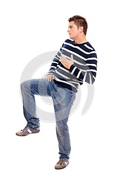 Young man standing on one leg