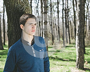 Young man standing outside in the forest