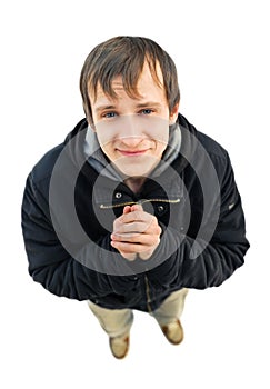 Young man standing with pleading look on white