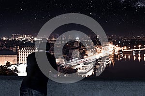 Young man standing on the roof of a tall building