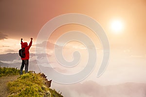 Young man standing on top of mountain