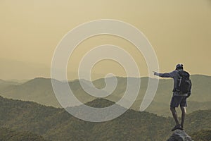 Young man standing on top of the mountain