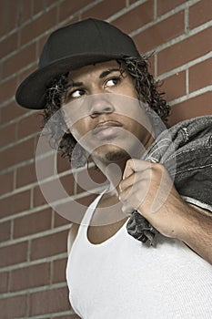 Young Man standing at wall