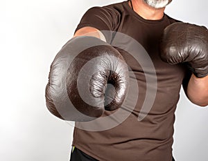 young man stands in a boxing rack