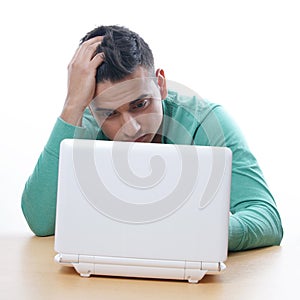 Young man staring at netbook
