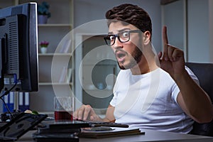 The young man staying late in office to do overtime work