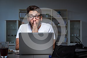 The young man staying late in office to do overtime work