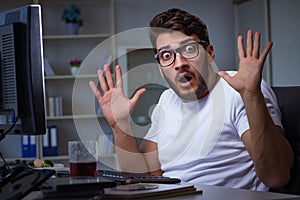 The young man staying late in office to do overtime work