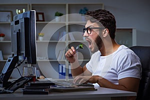 The young man staying late in office to do overtime work