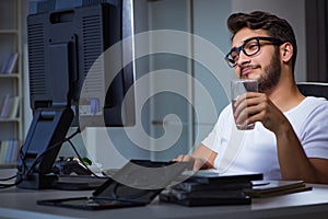 The young man staying late in office to do overtime work