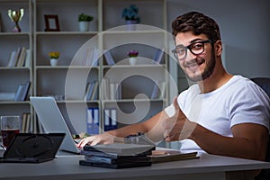 The young man staying late in office to do overtime work