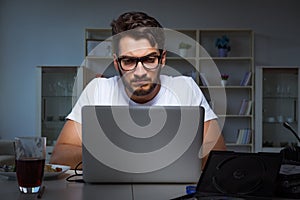 The young man staying late in office to do overtime work