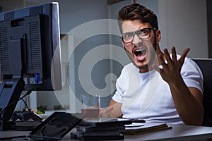 The young man staying late in office to do overtime work