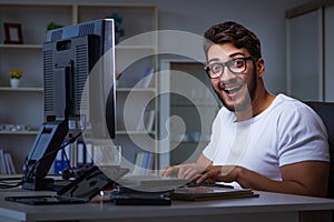 The young man staying late in office to do overtime work