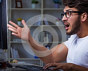 Young man staying late in office to do overtime work