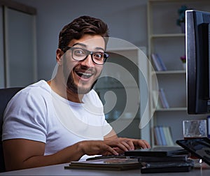 Young man staying late in office to do overtime work