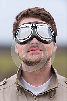Young man with steampunk aviator goggles