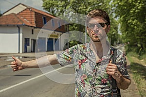 Young man stopping the car on the road