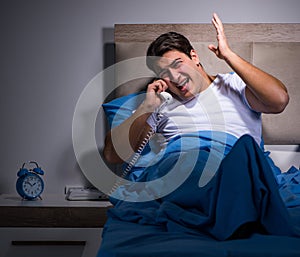 Young man struggling from noise in bed