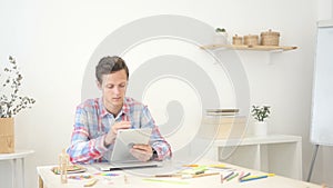 Young man / student , designer using tablet computer