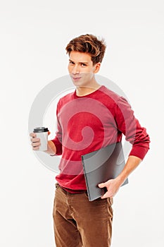 Young man student with funny sharming face holding laptop