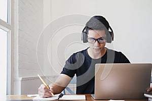 Young man student study at home using laptop and learning online