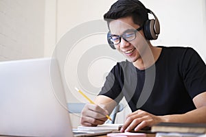 Young man student study at home using laptop and learning online