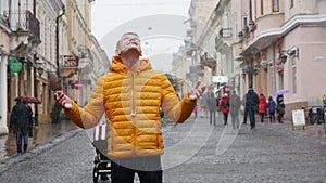 A Young Man Student talk to the Phone on the Winter Street in Europe