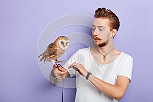 Young man studing the behavior of owls