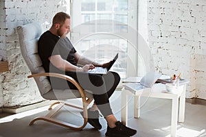 Young man studying at home during online courses for programmer, bug-tester, consulter