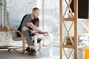 Young man studying at home during online courses for programmer, bug-tester, consulter