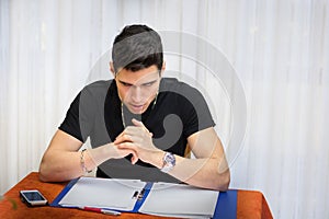 Young man studying or working at home with