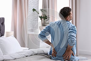 Young man suffering from back pain