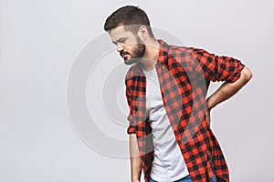 Young man suffering from back pain isolated on white background. Backache concept