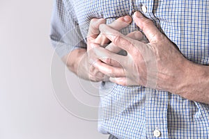 The young man is suffering from chest pain. Chest spasm, angina pectoris. Heart attack